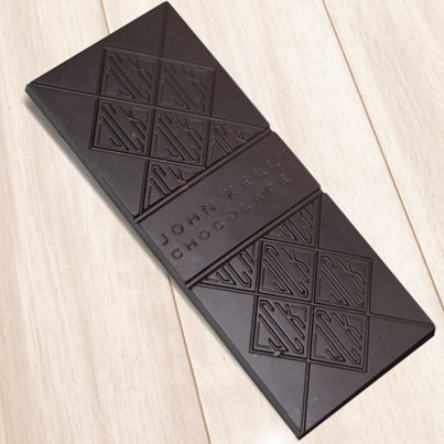 A dark chocolate bar. The bar has John Kelly Chocolates logo on it.