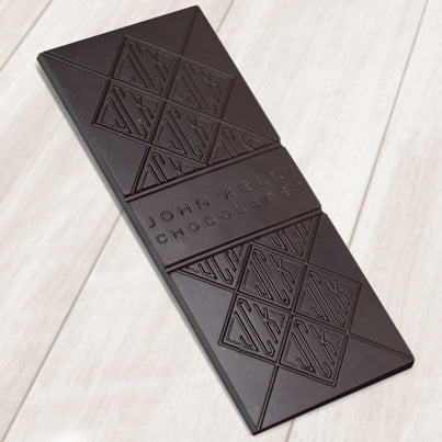 A dark chocolate bar. The bar has John Kelly Chocolates logo on it.