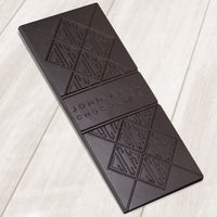 A dark chocolate bar. The bar has John Kelly Chocolates logo on it.