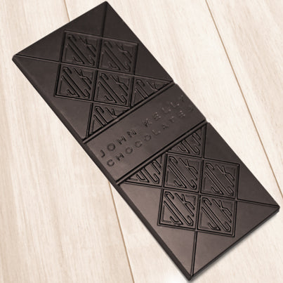 A dark chocolate bar. The bar has John Kelly Chocolates logo on it.