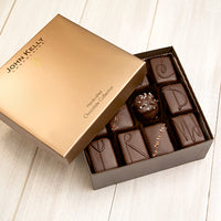 An open 24 piece assortment. Various chocolates from the assortment can be seen. The lid of the box sits partially on the box.