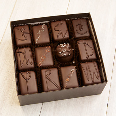 An open 24 piece assortment. Various chocolates from the assortment can be seen.