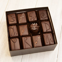An open 24 piece assortment. Various chocolates from the assortment can be seen.