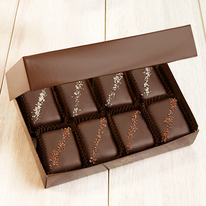 Eight salted chocolates in a dark brown box.