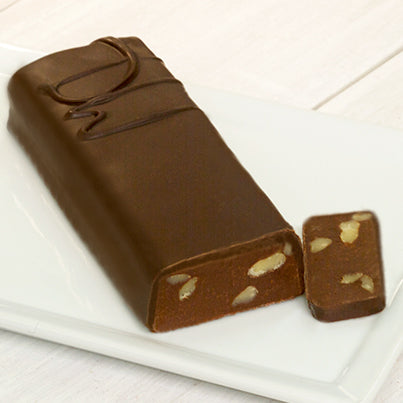 A long bar with a DW on it to signify it is dark chocolate with walnuts. A sliver at the end of the bar is cut off to reveal the chocolate and walnuts inside.