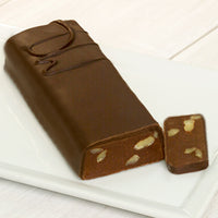 A long bar with a DW on it to signify it is dark chocolate with walnuts. A sliver at the end of the bar is cut off to reveal the chocolate and walnuts inside.