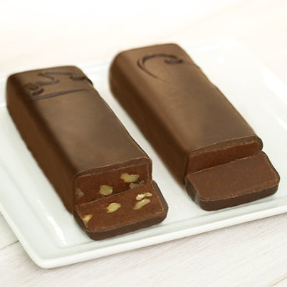 Two, long, rectangular chocolate bars with one of the ends cut off to reveal the inside. They are both semi-sweet, but one has walnuts in it.