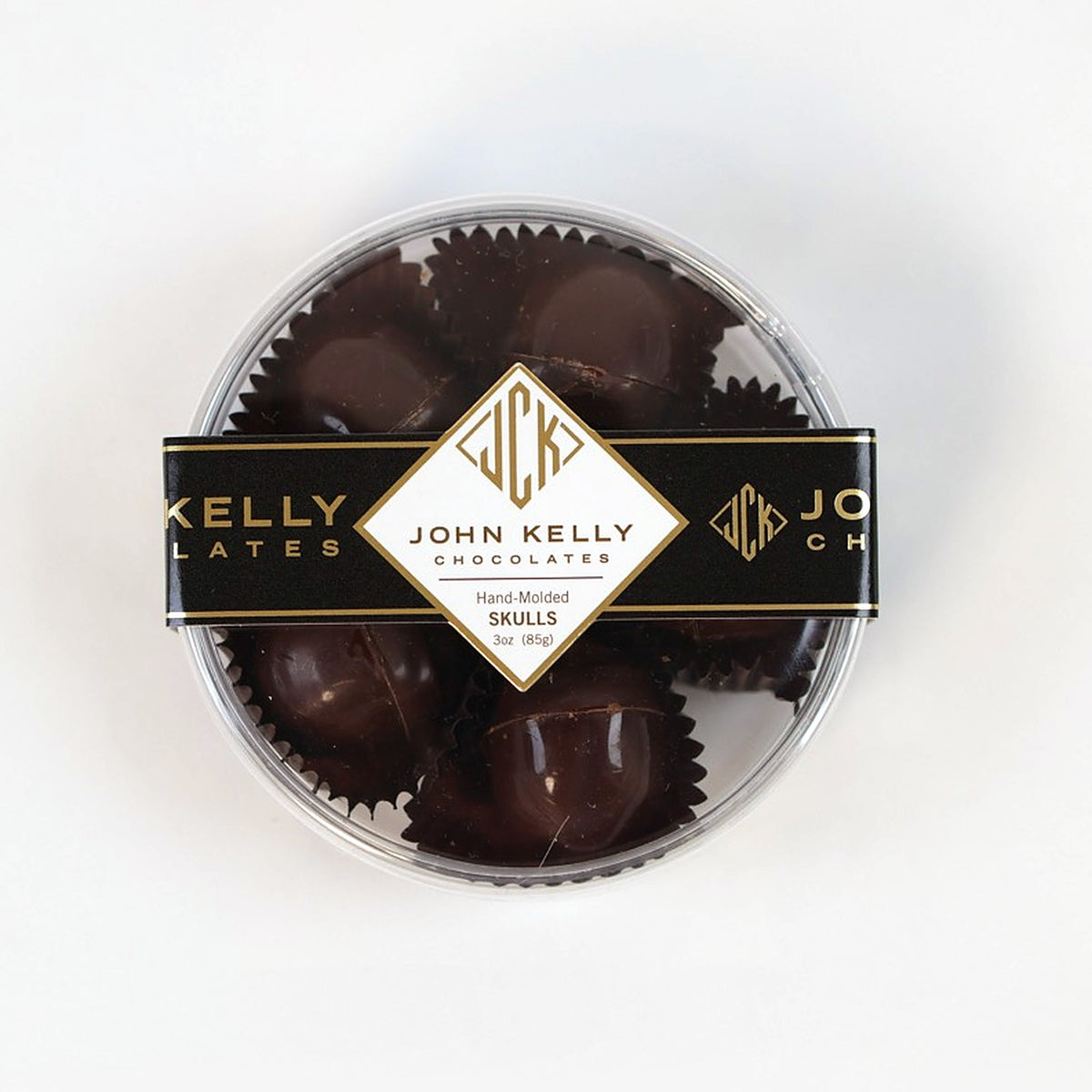 Five dark chocolate skulls in the clear gift box, top view