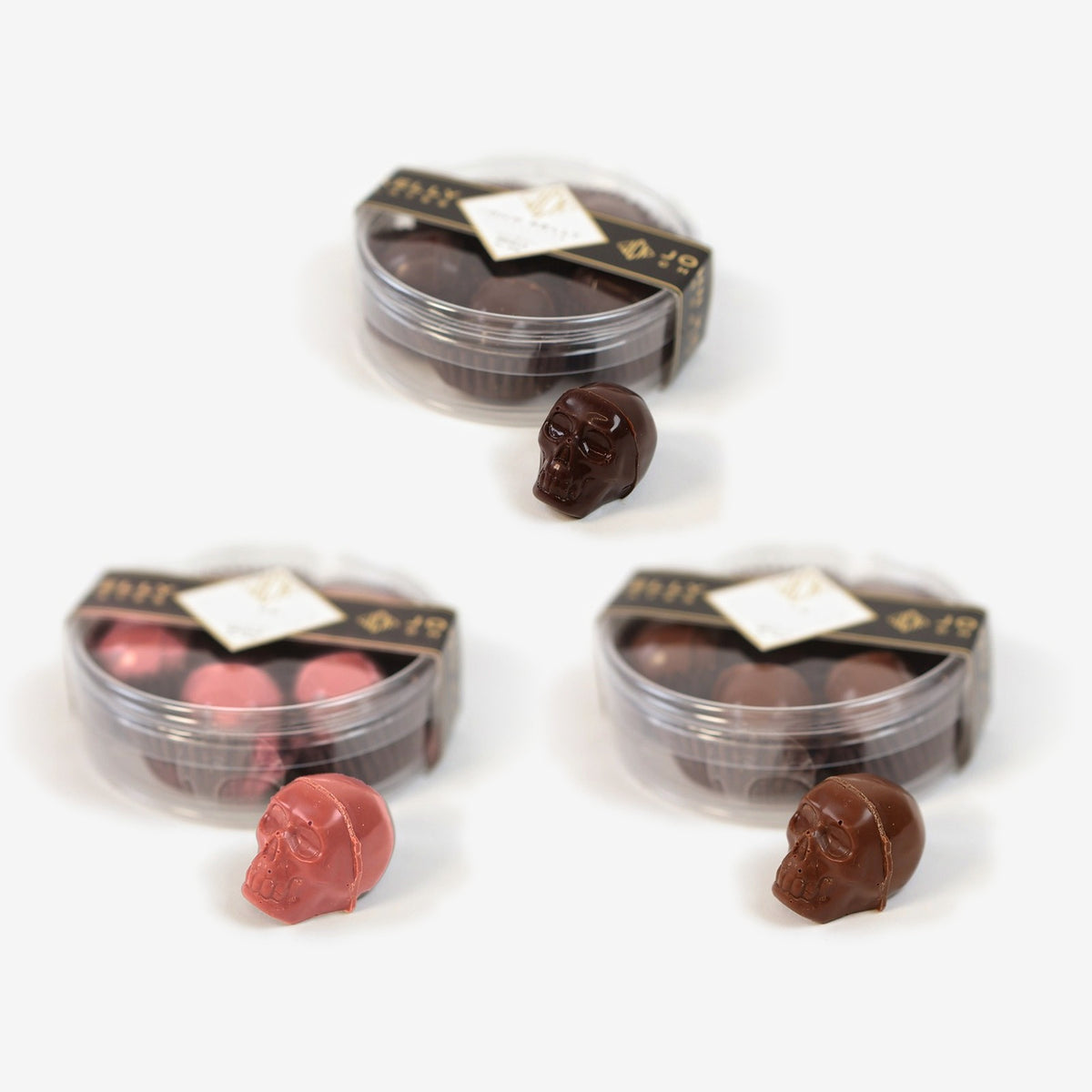 Filled Skulls Trio: garnet, dark chocolate and milk chocolate skull boxes, each with one skull in front