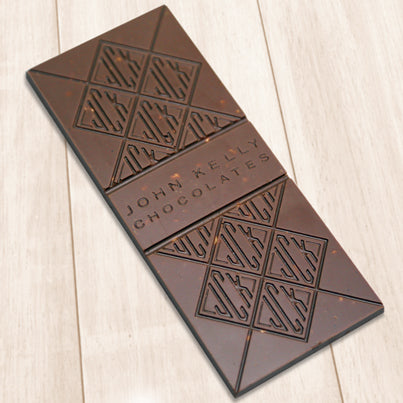 A milk chocolate bar. The bar has John Kelly Chocolates logo on it.
