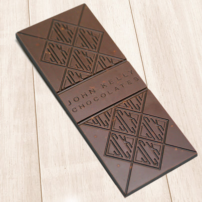 A milk chocolate bar. The bar has John Kelly Chocolates logo on it.