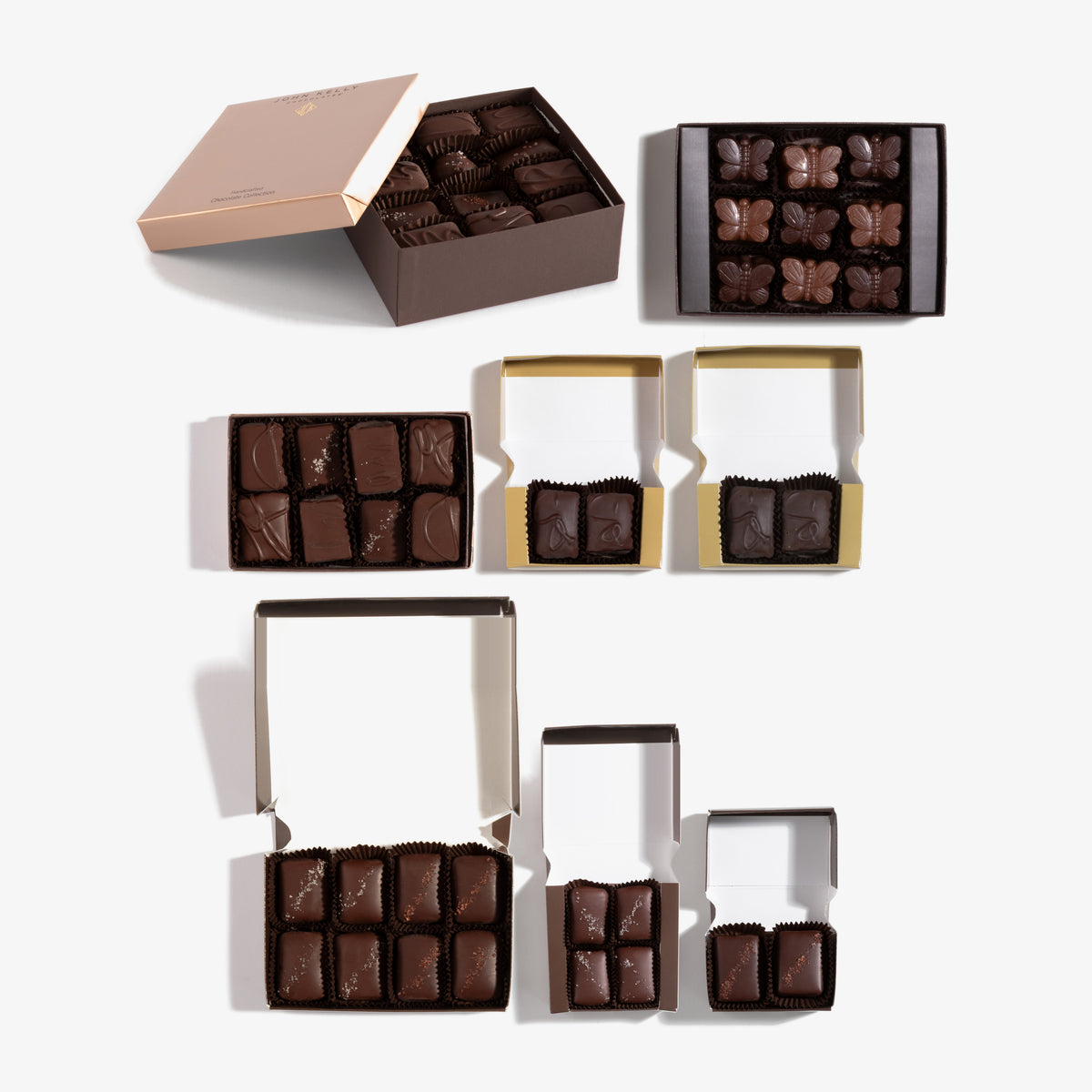 Grand Gift Tower, all eight boxes opened: 24pc Signature, 8pc Signature, 8pc Salted Chocolate Combo, 9pc Butterfly, 4pc Dark Chocolate with French Grey Sea Salt, 2pc Coconut, 2pc Chocolate & Caramel with Hawaiian Alaea Sea Salt, 2pc Signature