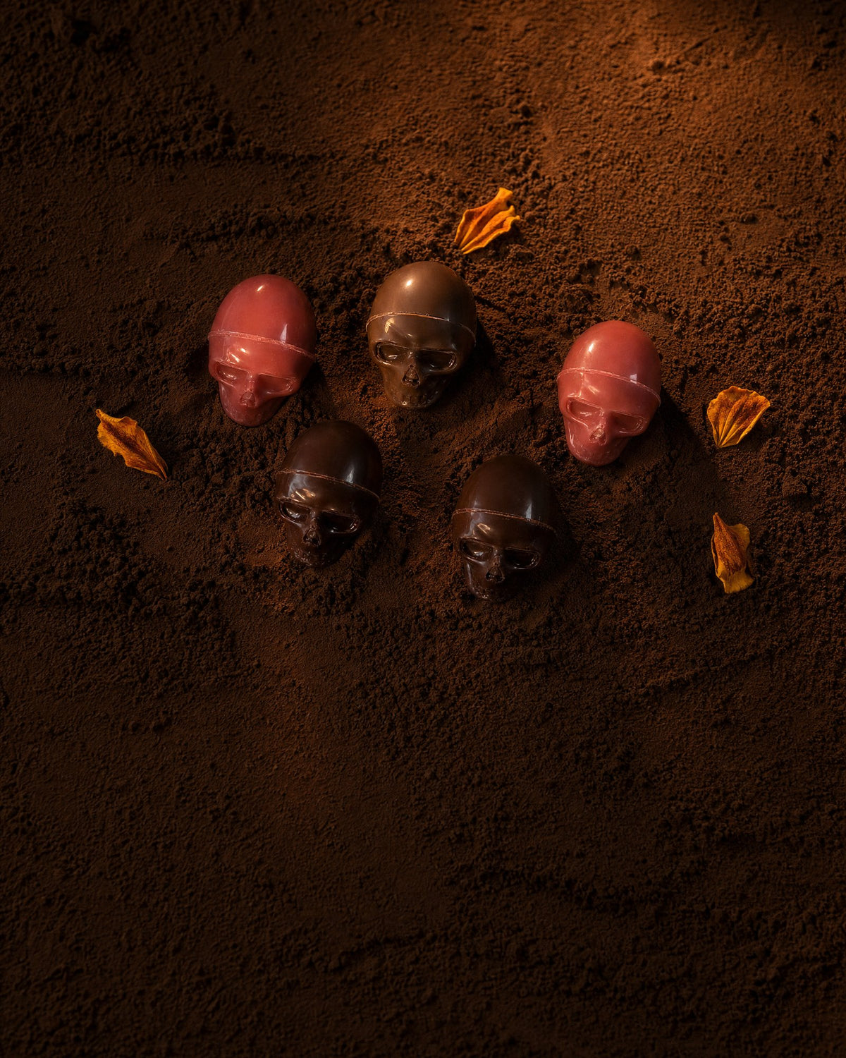 Hand-molded Halloween chocolate skulls in garnet, dark and milk chocolate