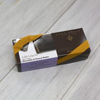 A semi-sweet chocolate and peanut butter 8oz bar box with gold ribbon