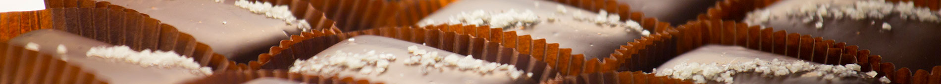 Salted chocolate sitting neatly in brown, paper cups.