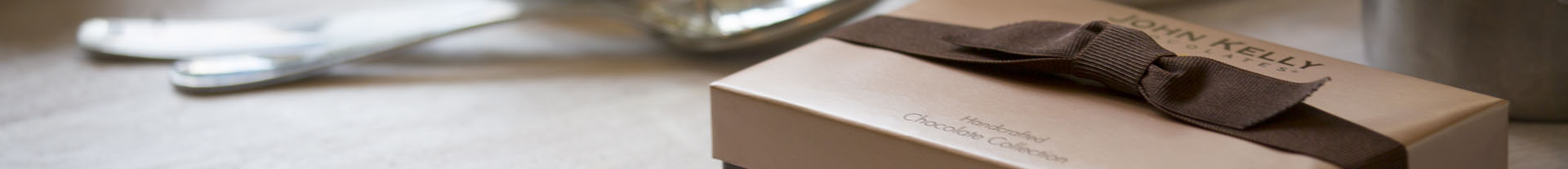 A brown box with a brown stretch ribbon sits on the right side of the banner.