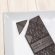 A dark solid bar with the top left corner cut off from it. The bar has a John Kelly Chocolates logo on it.