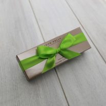 A closed four piece assortment. The box is in the shape of a rectangle and has a lime green bow on the front.