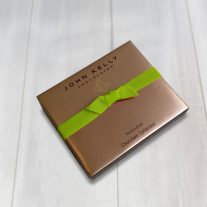 A Closed 6pc assortment box with a lime ribbon