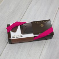 A dark chocolate 8oz bar box with a fuchsia ribbon. The box is brown and has a label on it with an image of the D on the dark chocolate bar.