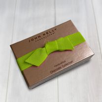 A closed two piece assortment with a lime ribbon